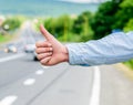Cultural difference. Thumb up inform drivers hitchhiking. But in some cultures gesture offensive risk to be killed by Royalty Free Stock Photo
