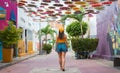 Cultural Exploration: Woman with Sunglasses and Headscarf Immersed in the Colorful Streets of Riohacha, Guajira