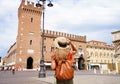 Cultural tourism in Italy. Rear view of female backpacker visiting old medieval town of Ferrara, Italy