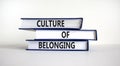 Culture of belonging symbol. Books with words `culture of belonging` on beautiful white background. Business, culture of belongi