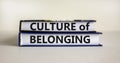 Culture of belonging symbol. Books with words `culture of belonging` on beautiful white background. Business, culture of belongi