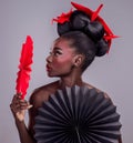 Culture, makeup and creative with black woman in studio for origami, art and beauty. Traditional, cosmetics and paper