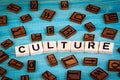 Culture word written on wood block. Wooden alphabet on a blue background