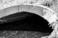 full capacity concrete culvert with sheen contaminated storm water runoff Royalty Free Stock Photo