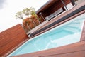 Cumaru decking, construction and cladding- swimming pool automatic sliding hardwood deck roof and garden pavilion gazebo Royalty Free Stock Photo