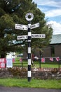 Traditional black and white signpost in the village of Greystoke, Cumbria