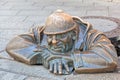 Cumil - statue of man peeking out from under a manhole cover Royalty Free Stock Photo