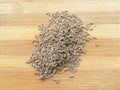 Cumin seeds heap on wooden background Royalty Free Stock Photo