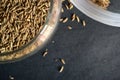 Top View Closeup Cumin seeds in a Open Transparent Glass jar On isolated Black Background Royalty Free Stock Photo