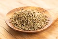 Cumin seeds on wooden spoon on table