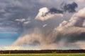 A cumulonimbus storm cloud over the fields and convective rainfall. Royalty Free Stock Photo