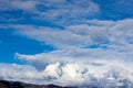 Cumulos, nimbus, clouds with angeles crest mountains, blue sky, sunlight,