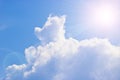 Cumulus and cirrus clouds and bright sunbeams against the blue sky. Atmospheric phenomenon, weather, summer