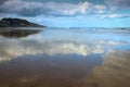 Cloudscapes reflected in wet sand on Makorori Beach, Gisborne, New Zealand