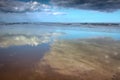 Cloudscapes reflected in wet sand on Makorori Beach, Gisborne, New Zealand