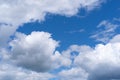 Cumulus clouds against a vibrant blue sky background