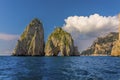 Cumulus clouds hover over the Faraglioni rocks on the eastern side of the Island of Capri, Italy Royalty Free Stock Photo