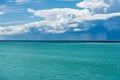 Cumulus Clouds with Torrential Rain on the Horizon over the Sea Royalty Free Stock Photo