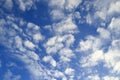 Cumulus small white clouds in the blue sky on an autumn, winter morning Royalty Free Stock Photo