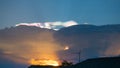 Cumulus sunset clouds with sun setting down