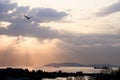 Cumulus sunset clouds with sun setting down light with sea and seagull