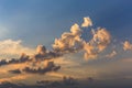 Cumulus sunset clouds with sun setting down