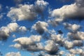 Cumulus white puffy fluffy clouds against deep blue sky Royalty Free Stock Photo