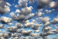 Cumulus white puffy fluffy clouds against deep blue sky Royalty Free Stock Photo