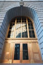 Cunard Line building door with building reflecting in the windows