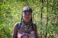 Portrait of Mucawana or Muhacaona tribe woman with beautiful colorful bead jewelry and elaborate hair