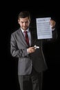 Cunning businessman holding contract and cigarette lighter