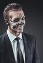 Cunning businessman with a makeup of the skeleton