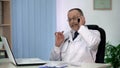 Cunning corrupt doctor hinting at bribe in phone conversation with patient