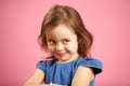 Cunning girl with a curious look looks to the side and is plotting something. Royalty Free Stock Photo