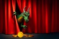 cunning green dragon holds a golden bitcoin in its paw, looking out from behind the red curtain