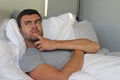 Cunning male plotting a revenge in bed Royalty Free Stock Photo