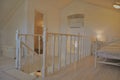 Cunski, Croatia-Losinj island November 2020. White attic with white wooden fence, part of double bed and stairs. Royalty Free Stock Photo