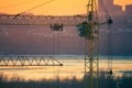 Cunstruction crane on the river sunset Royalty Free Stock Photo