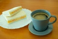 A Cup of Americano Black Coffee and Ham With Egg Sandwich on The Wooden Table