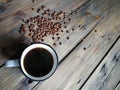 A cup of Americano on a wooden table. Next to the coffee beans. Royalty Free Stock Photo