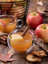 Cup of apple cider with cinnimon stick and sliced apple Royalty Free Stock Photo