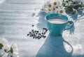 A cup of aromatic black coffee and coffee beans on the table