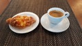 Cup of aromatic black coffee and croissant for a morning breakfast Royalty Free Stock Photo