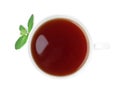 Cup of aromatic black tea with fresh mint on white background, top view Royalty Free Stock Photo