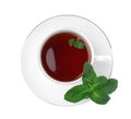 Cup of aromatic black tea with fresh mint on white background, top view Royalty Free Stock Photo