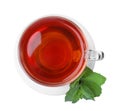 Cup of aromatic black tea with fresh mint on white background, top view Royalty Free Stock Photo