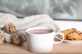 Cup of aromatic cacao on wooden table