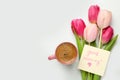 Cup of aromatic coffee, beautiful pink tulips and Good Morning note on white marble table, flat lay. Space for text Royalty Free Stock Photo