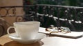 Cup of aromatic coffee, glasses and newspaper on wooden table outdoors. Space for text Royalty Free Stock Photo