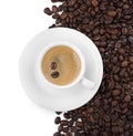 Cup with aromatic coffee and pile of beans on white background, top view Royalty Free Stock Photo